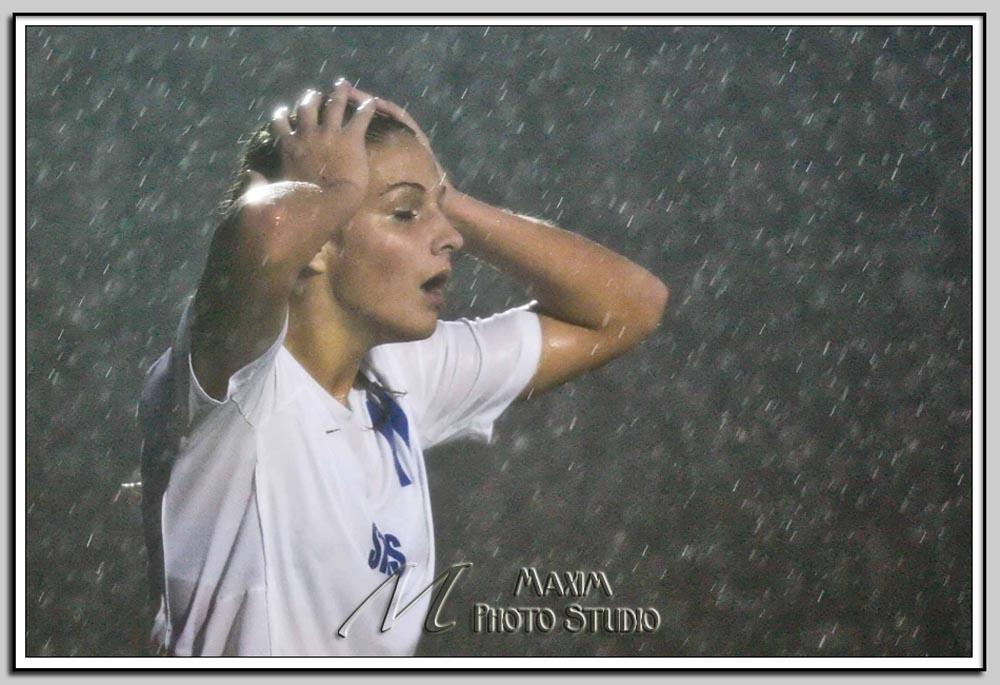 Brittney Nessle in the Rain Brittney Nessle wipes the rain from her face
